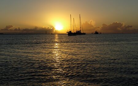 These cruising Sail boats and the Fishing Trawler were snapped at sunrise in the Burnett River entrance- Burnett Heads (Bundaberg)- Queensland -Australiaの写真素材