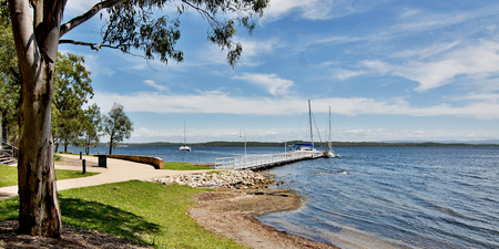 Murrays Beach wharf  in the green Murrays Beach waterfront parkland, Lake Macquarie, New South Wales, Australia.の写真素材