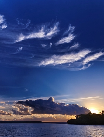 Sunrise seascape with vivid blue sky and white wispy clouds over ocean.Photograph at Tin can bay...