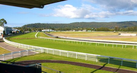 Racecourse panorama of a country Australian Grass racecource with green grass ,white fences, and white cloud in a blue sky.

Situated at Gosford, New South Wales, Australiaの写真素材