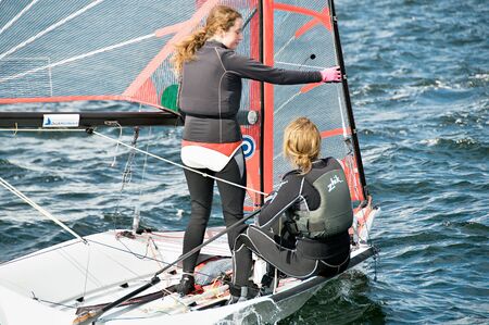 Lake Macquarie, Australia - April 16. 2013: Children competing in the Australian Combined High School Sailing Championships. Young contestants raced in various types of dinghies.のeditorial素材