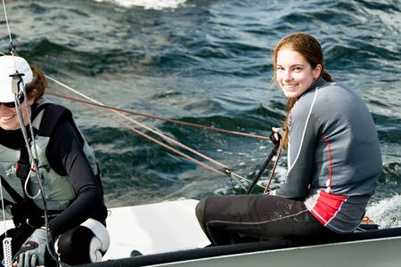 Lake Macquarie, Australia - April 16. 2013: Children competing in the Australian Combined High School Sailing Championships. Young contestants raced in various types of dinghies.のeditorial素材