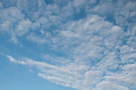 A heavenly meteorological sky cloudscape scene, with delicate white Altocumulus cloud formation in a blue sky. New South Wales, Australia.の写真素材
