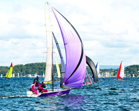 Children Sailing in colourful High  School  Sailing  Championships. 

Belmont, Lake Macquarie, New South Wales, Australia.の写真素材