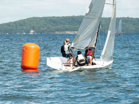 Young boys Sailing Racing small sailboat, rounding an orange marker. Teamwork by junior sailors racing on saltwater Lake Macquarie. Photo for commercial use.の写真素材