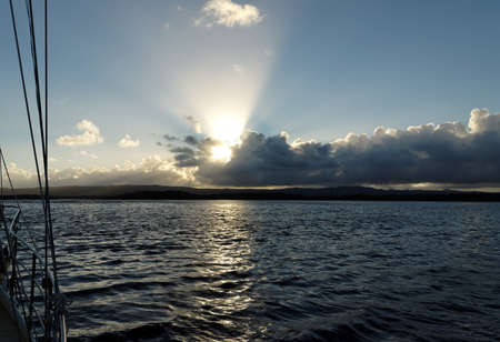 An unusual stratocumulus cloud Sunrise Seascape with crepuscular rays over grey sea water with clear reflections.

Queensland, Australia.の写真素材