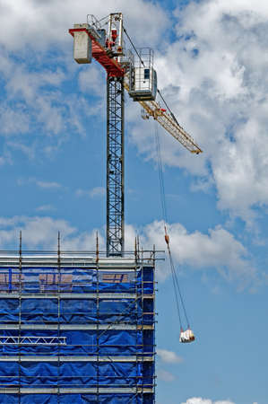 A tower crane working in high winds on new home units building site at 47 Beane St, Gosford, New South Wales, Australia - November 8. 2018: Construction and building progress update.のeditorial素材