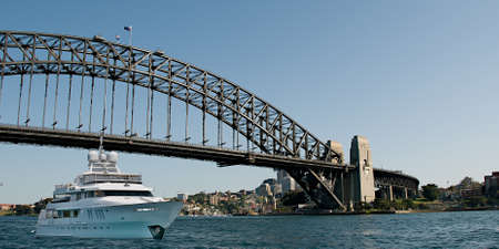 Super luxury 45mtr motor yacht passing under Sydney Harbour Bridge, Sydney Harbour, NSW, Australia.の写真素材