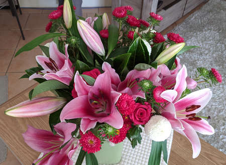 Floral display including Flashpoint pink and white Oriental Trumpet Lily closeup.Beauty in nature image.の写真素材