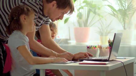Cute children use laptop for education, online study, home studying, Boy and Girl have homework at...