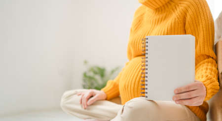 Pregnant woman hold blank white paper. Healthcare checkup during pregnancy. Medical card for...