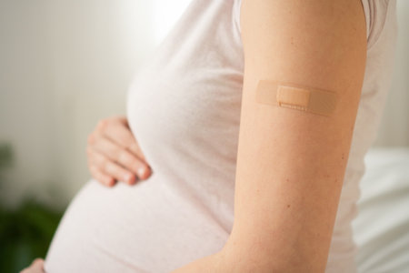Focus on vaccination bandage on pregnant womans arm. Responsible maternal healthcare through timely immunization during pregnancy.の写真素材