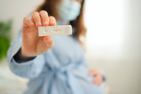 Expecting mother analyzing molecular diagnostic test outcome. Important infection control measure in...