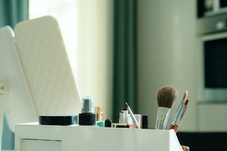 Close-up of makeup brushes and tools arranged in a stylish room for self-application. Focus on beauty accessories highlighting care and grooming essentials.の写真素材