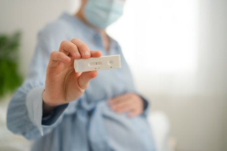 Expecting mother anxiously viewing PCR test results at home. Advanced diagnostics for infectious...