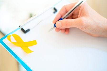 Close up of a person in uniform holding blank document with yellow ribbon.の写真素材