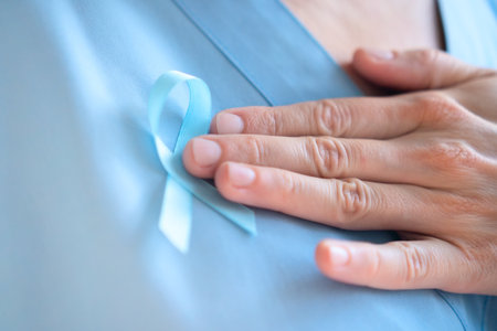 Medical woman in uniform with blue ribbon on chest holding clipboard. November prostate cancer awareness, early diagnosis, healthcare support, and prevention education.の写真素材