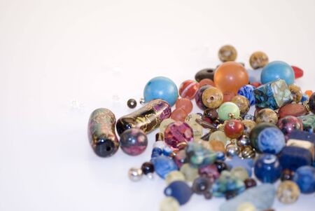 many colorful fancy glass beads on white backgroundの写真素材