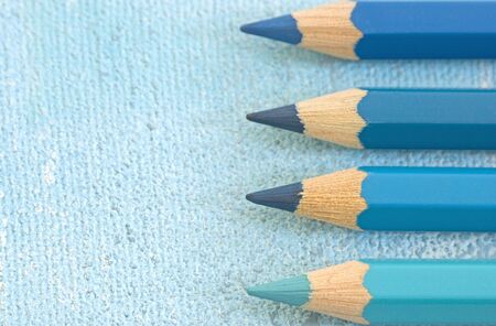 four pencil crayons in different shades of blueの写真素材