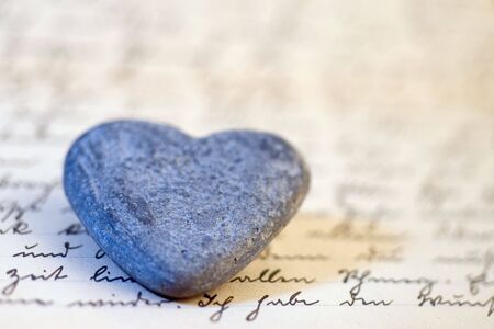 stone hearts on old handwritten letterの写真素材