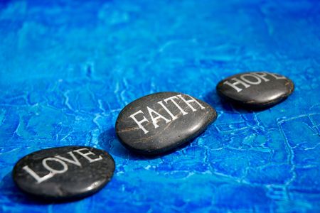 engraved stones with words love faith hopeの写真素材