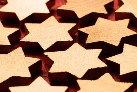 wooden christmas stars on red background