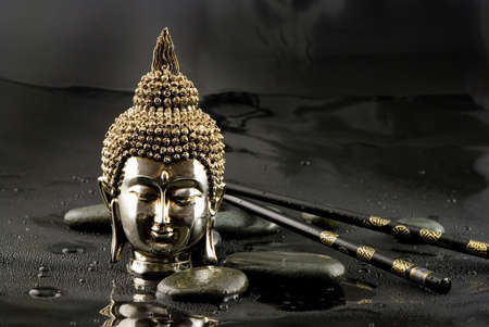 Buddha head with chopsticks