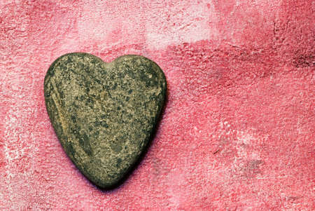 stone heart on pink backgroundの写真素材