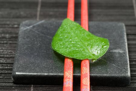 Asia still life with chopsticks and green leafの写真素材