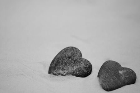 Two heart shaped stones on the beachの写真素材