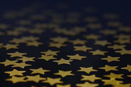 black background with golden christmas starsの写真素材