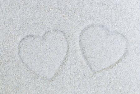 print of two hearts in the sandの写真素材