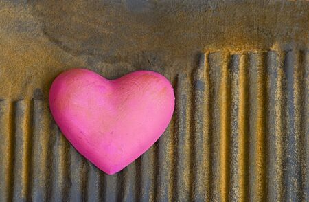 pink heart on rusty surfaceの写真素材