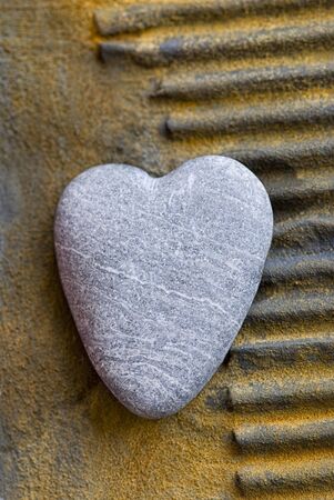 stone heart on rusty surfaceの写真素材