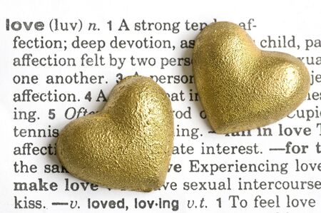 two golden hearts on dictionary love textの写真素材