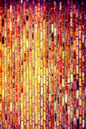 Vintage brick wall with some stones in it, abstract architecture backgroundの写真素材
