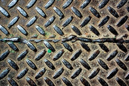 Vintage hammered metal ornament with diagonal lines with some rusty on it. Metal texture with diagonal linesの写真素材