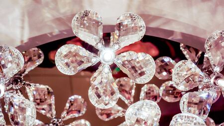 beautiful lamp with brillliant flowers with five petals shine inside, not alive flowers in luxure big chandalier shine like a brilliantの写真素材