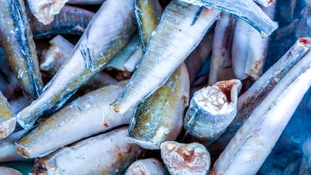 frozen fish body without head lay in market basket as food background top view. Fresh seafood. Fresh fish in the marketの写真素材