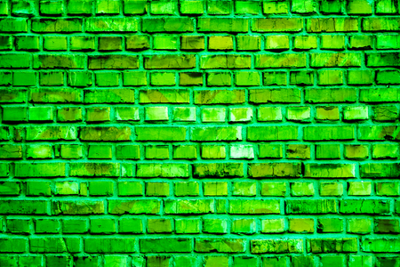 old different sizes red brick wall with cracked parts and light spots with some shadows as background. Colorful brick wall pattern, painted bricks as urban textureの写真素材