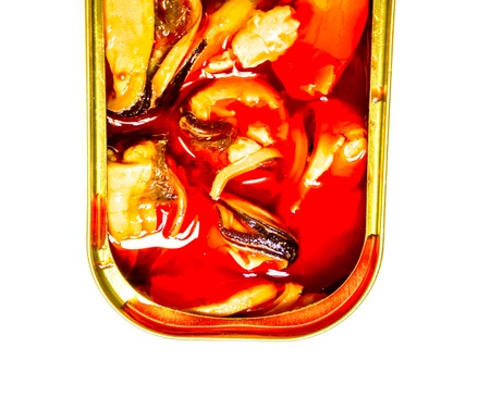 close-up of open metal can with delicacy. marinated square brilliant can with three orange mussels that swimming in orange golden oil against white background. Food Still Life with seafood delicaciesの写真素材