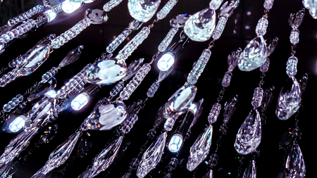 diagonal lines with mystery shining of luxury modern chandelier with beads and crystal tears, big shining chandeliers hanging in the form of droplets with an internal pattern and beadsの写真素材