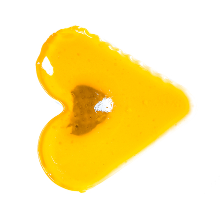 isolate fresh yellow orange jelly heart cake with berry inside as music play triangle button. sweet jelly heart-shaped cakes on white concrete background. valentine's heart love cake. Free space for text.の写真素材