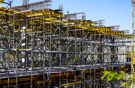 high metal Power Plant Construction made with metal horizontal and vertical pylonsagainst blue sky...