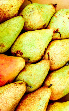 colorful fresh organic pears. sweet yellow pears lay in diagonal lines in box at the shop and wait for buyers. Tasty yellow pears in the box. natural fruit backgroundの写真素材