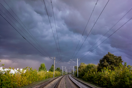 Industrial landscape with railroad, colorful cloudy blue sky. Railway sleepers. Railway junction. Heavy industry. Cargo shipping. Travel backgroundの写真素材