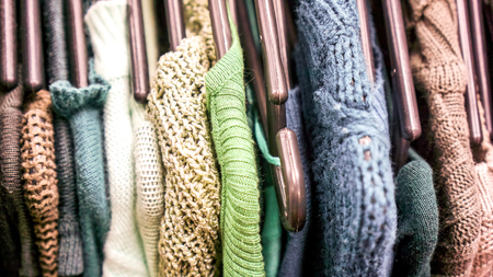 ivroy light clothes in pink lilian colors densely arranged on the shop rank. Clothing on hanger at the modern shop boutique. Different colorful clothes before sale seasonの写真素材