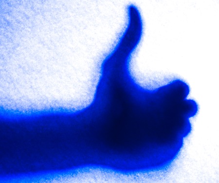 blue light silhoette of like hand in mystery light. colorful silhouettes of hands young woman and a...
