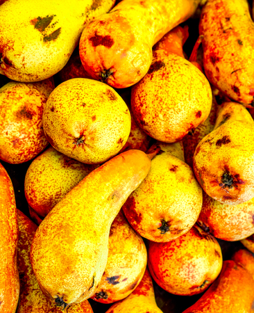natural yellow pears with black spots. fresh organic pears. sweet yellow pears lay in diagonal lines...