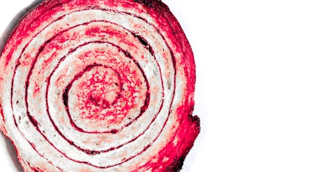isolated big sweet round cinnamon bun with dark spiral and texture of a porous dough inside with dark brown crispy crust. bun as sweet fresh snail on white backgroundの写真素材